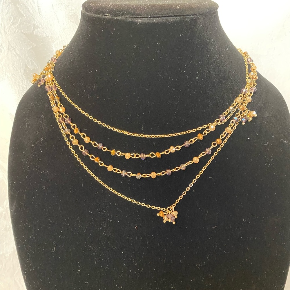 Sparkly long necklace w/purple stones, gold tone. Adj clasp. Perfect condition